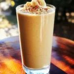 To make your High Protein Snickerdoodle Smoothie, gather these ingredients: - 1 cup unsweetened almond milk - 1 ripe banana - 1 scoop vanilla whey protein powder - 1 tablespoon almond butter - 1 teaspoon cinnamon - 1/2 teaspoon vanilla extract - 1 tablespoon maple syrup (optional for sweetness) - 1/4 cup rolled oats - Ice cubes (as needed for thickness) Each ingredient adds unique benefits to the smoothie. - Almond Milk: It is low in calories and high in vitamin E. - Banana: This fruit adds natural sweetness and provides potassium. - Vanilla Whey Protein Powder: It boosts protein content, promoting muscle health. - Almond Butter: Packed with healthy fats, it keeps you full longer. - Cinnamon: This spice adds flavor and may help regulate blood sugar. - Vanilla Extract: It enhances taste without added sugar. - Maple Syrup: Use it for a touch of sweetness if needed. - Rolled Oats: They offer fiber and help with digestion. - Ice Cubes: These make the smoothie cold and thick. You can easily modify the recipe to suit your needs. - For Dairy-Free: Use oat milk or coconut milk instead of almond milk. - For Vegan: Choose plant-based protein powder in place of whey. - For Nut Allergies: Substitute almond butter with sunflower seed butter. - For Lower Sugar: Omit maple syrup and rely on the banana for sweetness. - For Gluten-Free: Ensure your oats are certified gluten-free. These swaps keep the taste and nutrition while meeting your dietary needs. To make this smoothie, start by gathering your ingredients. You need: - 1 cup unsweetened almond milk - 1 ripe banana - 1 scoop vanilla whey protein powder - 1 tablespoon almond butter - 1 teaspoon cinnamon - 1/2 teaspoon vanilla extract - 1 tablespoon maple syrup (optional for sweetness) - 1/4 cup rolled oats - Ice cubes (as needed for thickness) 1. First, add the almond milk to your blender. 2. Next, peel and break the ripe banana into chunks. Toss it in. 3. Add the scoop of vanilla whey protein powder. This adds protein and flavor. 4. Spoon in the almond butter for healthy fats and creaminess. 5. Sprinkle in the cinnamon and vanilla extract. This gives the smoothie its snickerdoodle taste. 6. If you want it sweeter, add the maple syrup. 7. Toss in the rolled oats for a bit more texture and protein. 8. Blend everything on high speed until it’s smooth and creamy. To get the right thickness, consider these tips: - If the smoothie is too thin, add more rolled oats or ice cubes. - If it's too thick, add a splash more of almond milk. - Always blend on high for a smooth finish. Avoid these common pitfalls: - Don’t skip the ice cubes if you want a cold smoothie. - Make sure your banana is ripe for the best flavor. - Avoid adding too much maple syrup at once; you can always add more later. - Don’t forget to taste your smoothie before serving! Adjust the sweetness if needed. To make your smoothie super creamy, use ripe bananas. They add natural sweetness and a silky texture. Another great tip is to choose unsweetened almond milk. It blends well and keeps the flavor light. If you want extra creaminess, try adding a bit of almond butter. It boosts both flavor and protein. While cinnamon shines in this smoothie, you can add more flavors. Consider a dash of nutmeg for warmth. A little cocoa powder gives it a chocolate twist. For a fruitier note, try adding a handful of berries. These options keep your smoothie exciting and fun. To save time, prep your ingredients ahead. You can slice bananas and store them in the freezer. This way, you always have a cold base ready. Also, measure out your protein powder and oats in advance. Keep them in a container for quick access. These tricks make smoothie-making a breeze, even on busy mornings. {{image_2}} You can easily make this smoothie dairy-free and vegan. Simply switch the vanilla whey protein powder for a plant-based protein. Look for options like pea or rice protein. Use unsweetened almond milk, as it’s already dairy-free. Almond butter adds creaminess, but you can also try peanut or sunflower seed butter. These swaps keep the taste rich and smooth. If you want to cut back on sugar, there are great alternatives. Instead of maple syrup, try using dates or stevia. Dates add natural sweetness and fiber. Stevia is a zero-calorie sweetener that works well in smoothies. You can also skip sweeteners altogether for a less sugary option. The ripe banana already adds some sweetness. You can change the flavors by using seasonal ingredients. In fall, add pumpkin puree and spice it up with nutmeg. In summer, fresh berries like strawberries or blueberries offer a fruity twist. Each season brings new tastes, keeping your smoothie exciting. Don’t be afraid to explore different flavors with your ingredients! To store your High Protein Snickerdoodle Smoothie, pour any leftovers into a clean container. Seal it tightly to keep air out. This helps keep the smoothie fresh. Store it in the fridge for up to 24 hours. Beyond that, the taste and texture may change. You can freeze the smoothie for later. This is a great way to save a tasty treat. Pour the smoothie into ice cube trays or freezer bags. If you use bags, squeeze out the air before sealing. This keeps the smoothie from getting freezer burn. When you are ready to enjoy it, blend the frozen cubes with a splash of almond milk until smooth. For storing your smoothie, I recommend using glass jars or BPA-free plastic containers. Glass keeps flavors fresh and is easy to clean. Plastic containers are lightweight and perfect for on-the-go. Make sure your container has a tight lid to prevent leaks. If you want to take your smoothie with you, choose a travel mug with a straw for easy sipping. This smoothie packs a protein punch. The vanilla whey protein powder boosts muscle recovery. Almond milk offers low calories and is dairy-free. Bananas add potassium, which helps heart health. Oats provide fiber, promoting good digestion. Cinnamon can help regulate blood sugar. Overall, this smoothie supports energy and satiety. Yes, you can! Blend all the ingredients and store it in the fridge. For best taste, drink within 24 hours. Just give it a shake or stir before you enjoy it. If you want to prep several servings, consider freezing portions. Thaw in the fridge overnight for a quick treat. To boost protein, add more whey protein powder. You can also mix in Greek yogurt. Silken tofu is another great option for a creamy texture. Chia seeds are rich in protein and fiber, too. Each of these options will enhance the smoothie without changing the flavor much. Yes, it can work as a meal replacement. It has protein, carbs, and healthy fats. The oats and banana provide energy, while almond butter adds healthy fats. Just ensure it fits your daily calorie needs. If you want a heartier meal, add more oats or a side of fruit. If you need a substitute, try oat milk or coconut milk. Soy milk is another excellent choice for protein. Regular dairy milk works well too if you’re not dairy-free. Just remember, each option will slightly change the flavor and texture. Choose what fits your taste best! This blog shared how to create a high protein snickerdoodle smoothie. We explored key ingredients and their benefits. You learned how to prep with care and avoid common mistakes. We discussed ways to make it creamy and tasty. You can also swap ingredients to fit your diet. Storing tips let you keep leftovers fresh for later. In all, this smoothie is packed with flavor and nutrition. Enjoy making it your way!