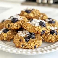 Making blueberry oatmeal breakfast cookies is simple and fun. Here’s what you need: - 1 cup rolled oats - 1/2 cup whole wheat flour - 1/2 cup almond flour - 1/3 cup maple syrup - 1/4 cup unsweetened applesauce - 1/2 cup fresh blueberries - 1/4 cup unsweetened shredded coconut - 1 tsp baking powder - 1/2 tsp cinnamon - 1/4 tsp salt - 1/4 cup chopped nuts (walnuts or pecans) - 1/2 tsp vanilla extract Each ingredient plays a key role in making these cookies tasty. The oats give a chewy texture. Whole wheat flour adds fiber. Almond flour provides a rich flavor. Maple syrup and applesauce keep the cookies moist and sweet. Fresh blueberries burst with juice, making each bite delightful. Shredded coconut adds a fun twist. Baking powder helps them rise. Cinnamon and salt enhance the overall taste. Finally, nuts add crunch and healthy fats. When gathering your ingredients, choose fresh blueberries for the best flavor. If you want a nut-free version, simply skip the nuts. This recipe is flexible and can fit many diets. Enjoy the process and get ready for delicious cookies! {{ingredient_image_1}} First, set your oven to 350°F (175°C). This helps the cookies bake evenly. While it heats, line a baking sheet with parchment paper. This will keep your cookies from sticking. In a large bowl, combine the rolled oats, whole wheat flour, almond flour, baking powder, cinnamon, and salt. Mix until everything is even. This step is key for the right texture. In another bowl, whisk together the maple syrup, applesauce, and vanilla extract. Make sure to mix until it is nice and smooth. This mix adds sweetness and moisture to your cookies. Pour the wet mix into the dry mix. Stir gently until just combined. Now, fold in the fresh blueberries, shredded coconut, and chopped nuts. Be careful not to mash the blueberries. You want them whole for bursts of flavor! Using a tablespoon or cookie scoop, drop rounded dollops of dough onto the prepared baking sheet. Space them about 2 inches apart. This spacing allows the cookies to spread while baking. Place the baking sheet in the oven. Bake for 10-12 minutes. Watch for the edges to turn slightly golden. When the tops look set, they are ready! Once baked, remove the cookies from the oven. Let them cool on the baking sheet for about 5 minutes. After that, transfer them to a wire rack to cool completely. Enjoy them warm or store for later! To get the right texture for your cookies, follow a few key steps. First, use rolled oats for a chewy base. They help give the cookies a hearty feel. Next, be careful when mixing the dough. Overmixing can break the blueberries and change the texture. Mix just until you see no dry flour. Finally, let the cookies cool on a wire rack. This keeps them from getting soggy. Storing these cookies is simple. Place them in an airtight container. This keeps them fresh for up to a week. If you want to keep them longer, you can store them in the fridge. Just make sure they cool completely first. For added flavor, you can warm them in the microwave for a few seconds before eating. Freezing cookie dough is a great option. You can scoop the dough into balls and place them on a baking sheet. Freeze them until hard, then transfer to a freezer bag. This way, you can bake fresh cookies anytime. Just bake from frozen, adding a minute or two to the baking time. It’s the perfect way to enjoy warm cookies anytime! Pro Tips Store in an Airtight Container: To keep your cookies fresh longer, store them in an airtight container at room temperature. Swap the Sweetener: You can replace maple syrup with honey or agave nectar for a different flavor profile. Add More Flavor: Feel free to experiment by adding a pinch of nutmeg or a teaspoon of lemon zest for an extra flavor boost. Chill the Dough: For thicker cookies, chill the dough in the fridge for about 30 minutes before baking. {{image_2}} You can easily adjust this recipe. For gluten-free cookies, use certified gluten-free oats and a gluten-free flour blend. If you are nut-free, swap almond flour for more whole wheat flour or oat flour. This keeps the texture light and chewy. For a vegan option, replace maple syrup with agave syrup. You can also skip the eggs by using a flax egg: mix one tablespoon of flaxseed meal with three tablespoons of water and let it sit for a few minutes. Want to boost the flavor? Add chocolate chips! Dark chocolate pairs well with blueberries. You can also mix in spices like nutmeg or ginger for a warm touch. Try 1/4 teaspoon of nutmeg or a pinch of ginger to change the taste. You can also add a handful of chopped nuts like walnuts or pecans for extra crunch. You can switch the blueberries for other fruits. Raspberries add a tart flavor that is delicious. Cranberries can give a festive touch, especially in the fall. If you want a sweeter option, try dried cherries or figs. Each fruit adds a unique flavor and keeps the cookies fresh and exciting. Serve these cookies warm with a side of yogurt. The creaminess of yogurt balances the sweetness of the cookies. Add extra blueberries on top for a pop of color and more flavor. You can use Greek yogurt for a protein boost or a dairy-free option if needed. This pairing makes for a nourishing breakfast that keeps you full. These cookies are perfect for a busy morning. Just grab one or two as you head out the door. They are easy to pack and taste great at room temperature. Their blend of oats and fruit provides energy to kickstart your day. You can also pack them in your lunch box or as a snack for school. Get creative with how you serve these cookies. Try crumbling them over a smoothie bowl for added texture. You could also layer them in a parfait with yogurt and fruit. Another fun idea is to serve them with nut butter spread on top for a unique twist. These options can turn your simple breakfast into something special. To make these cookies gluten-free, swap the whole wheat flour with a gluten-free blend. Many brands offer great options that work well in baking. Check the ingredients to ensure they contain no gluten. This change keeps the cookies tasty and safe for those with gluten sensitivities. Yes, you can use frozen blueberries. They add flavor and nutrition, just like fresh ones. However, remember to thaw them first. Pat them dry with a paper towel to avoid extra moisture in the cookies. This helps keep the texture right. These cookies last about five days at room temperature. Store them in an airtight container to keep them fresh. If you want them to last longer, you can freeze them. They freeze well for up to three months. Just thaw them at room temperature when ready to eat. You can add many healthy toppings to these cookies. Try yogurt for creaminess and extra protein. A sprinkle of nuts adds crunch and healthy fats. Fresh fruit, like banana slices or more blueberries, enhances the flavor and nutrition. Honey or nut butter can also make a tasty drizzle. This post shared a simple cookie recipe with healthy ingredients. You learned how to mix oats, nut flours, and fruits to create tasty treats. I covered tips for texture and storing cookies, plus fun variations to try. These cookies are perfect for breakfast or snacks. Enjoy the process of baking and get creative with flavors! Remember, making healthy choices can be easy and fun. Now, it’s time to gather your ingredients and start baking!