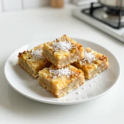To make these delightful Tropical Pineapple Coconut Bars, you need the following ingredients: - 1 cup crushed pineapple, drained - 1 cup shredded coconut (sweetened or unsweetened, based on preference) - 1 cup all-purpose flour - 1/2 cup granulated sugar - 1/2 cup unsweetened coconut milk - 1/4 cup unsalted butter, melted - 2 large eggs - 1 teaspoon baking powder - 1/2 teaspoon vanilla extract - A pinch of salt Each ingredient plays a key role in the flavor and texture of the bars. For instance, the crushed pineapple adds a juicy sweetness. The shredded coconut gives a lovely chewy texture. Using both all-purpose flour and baking powder helps the bars rise and stay soft. The eggs bind everything together, while the melted butter adds richness. You can choose sweetened or unsweetened coconut based on your taste. If you want a richer coconut flavor, use unsweetened coconut. The coconut milk makes the bars moist and creamy. Don't forget the pinch of salt! It enhances the sweetness and balances the flavors perfectly. These ingredients work together to create a tropical taste that feels like a sunny getaway. {{ingredient_image_1}} First, set your oven to 350&deg;F (175&deg;C). This step warms up the oven now. Next, take a 9x9 inch baking pan. Grease it with non-stick spray or line it with parchment paper. Doing this helps the bars come out easily. In a mixing bowl, add 1 cup of drained crushed pineapple. Then, add 1 cup of shredded coconut. You can choose sweetened or unsweetened coconut. Next, pour in 1/2 cup of melted unsalted butter. Then, add 1/2 cup of coconut milk and 1/2 teaspoon of vanilla extract. Mix these well until they blend completely. In another bowl, whisk together 1 cup of all-purpose flour, 1/2 cup of granulated sugar, 1 teaspoon of baking powder, and a pinch of salt. This mix adds structure and sweetness to your bars. Make sure there are no lumps in the flour. In a small bowl, crack 2 large eggs and beat them until they are frothy. Slowly fold these eggs into your wet mixture. Be gentle as you mix; you want everything to blend without overmixing. A few lumps are just fine. Now, pour the batter into your prepared baking pan. Make sure to spread it evenly into the corners. Bake it in the oven for 25 to 30 minutes. The bars are done when the top is golden brown and a toothpick comes out clean. Once baked, let the bars cool in the pan for about 10 minutes. Then, move them to a wire rack to cool completely. After cooling, slice them into bars and enjoy! To get the best texture in your Tropical Pineapple Coconut Bars, watch your mixing. Mix the wet and dry ingredients just until they come together. Overmixing makes the bars tough. You want them soft and chewy. If you see a few lumps, that&rsquo;s okay. They will bake out and create a wonderful texture. If you want sweeter bars, add more sugar. Start with an extra tablespoon. For more coconut flavor, use sweetened shredded coconut. Unsweetened coconut gives a milder taste. You can also add a splash of coconut extract if you like. These bars taste great on their own, but you can dress them up! Try topping them with extra shredded coconut. A drizzle of melted chocolate can also add a nice touch. For a fun twist, serve them with a scoop of vanilla ice cream. Enjoy them with friends or at a party! Pro Tips Use Fresh Ingredients: For the best flavor, use fresh crushed pineapple instead of canned. If using canned, ensure it is well-drained. Adjust Sweetness: Depending on your preference, you can adjust the amount of sugar based on the sweetness of your pineapple and coconut. Cooling Time: Allow the bars to cool completely before slicing to ensure clean cuts and to prevent them from crumbling. Add Texture: Consider adding chopped nuts or chocolate chips to the batter for an extra layer of texture and flavor. {{image_2}} You can make these bars gluten-free easily. Just swap the all-purpose flour with a gluten-free blend. Look for blends that work well in baking. They should include xanthan gum. This will help give your bars the right texture. Your friends won&rsquo;t even know they are gluten-free! Feel free to add more tropical fruits. Mango, banana, or papaya work great. Dice them small so they mix well. You can add about half a cup of these fruits. This will make your bars even more flavorful and fun. Think of it as a mini tropical vacation in every bite! You can choose between sweetened and unsweetened coconut. Sweetened coconut adds extra sugar and a rich taste. Unsweetened coconut gives a more natural coconut flavor. Both types work well in the recipe. Pick the one that fits your taste! If you want a less sweet bar, go for unsweetened. To keep your Tropical Pineapple Coconut Bars fresh, store them in an airtight container. Place parchment paper between layers to prevent sticking. These bars do best in the fridge. They can last up to a week when stored properly. If you want to save some bars for later, freezing is a great option. Wrap each bar in plastic wrap, then place them in a freezer bag. Squeeze out as much air as possible before sealing. They will stay fresh for about three months. When you&rsquo;re ready to enjoy, just thaw them in the fridge overnight. These tasty bars have a shelf life of about one week in the fridge. If you freeze them, they remain good for about three months. Always check for signs of spoilage before eating. If they smell off or have changed color, it&rsquo;s best to toss them. Enjoy these delightful treats fresh for the best taste! Yes, you can use fresh pineapple. Just make sure to crush it well and drain any excess juice. This will help keep your bars from being too wet. Fresh pineapple adds a bright flavor, making your bars even tastier. You can tell the bars are done when the top is golden brown. Insert a toothpick into the center. If it comes out clean, your bars are ready. The edges may pull away from the pan slightly, which is a good sign. If you need a substitute for coconut milk, try using almond milk or oat milk. These options will still give you a nice flavor. Coconut cream is another choice if you want a richer texture. Yes, you can make these bars vegan! Replace the eggs with flax eggs or applesauce. Use a plant-based butter instead of regular butter. Ensure your coconut milk is also plant-based. These swaps will keep your bars delicious and vegan-friendly. We explored making delicious tropical pineapple coconut bars with simple steps. I shared key ingredients, like pineapple, coconut, and butter, that create a tasty treat. You learned how to mix and bake for the right texture. I also included tips to adjust sweetness and serving ideas to make them special. Don&rsquo;t forget variations, like gluten-free or adding fruits. Store leftover bars properly to enjoy later. Now you have everything you need to create this awesome dessert! Enjoy your baking!